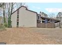 Exterior view of the home with bare yard, wood deck, and a covered patio at 26 Cobblestone Crk, Peachtree City, GA 30269