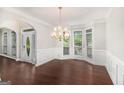 Elegant dining room featuring a chandelier, hardwood floors, and many windows at 1085 Crown River Pkwy, Mcdonough, GA 30252