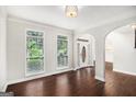 Spacious living room with hardwood floors and large windows allowing for natural light at 1085 Crown River Pkwy, Mcdonough, GA 30252