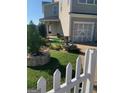 Charming home exterior featuring a well-manicured front yard, quaint fountain, and a two-car garage at 2681 Mariner Way, Villa Rica, GA 30180
