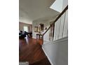Open-concept living space featuring hardwood floors and arched doorway, seamlessly connecting to other areas at 2681 Mariner Way, Villa Rica, GA 30180