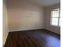 Empty bedroom showcasing hardwood floors and a bright window at 9022 Homewood Dr, Riverdale, GA 30274