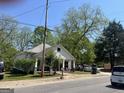 Side angle shot of a single-story home, showcasing a well-maintained front yard and covered front porch at 3143 S West St, Covington, GA 30014