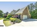 Brick home with a side-entry garage and lush landscaping at 330 Noah Pl, Mcdonough, GA 30252