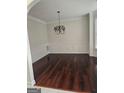 Elegant dining room featuring hardwood floors and classic chandelier lighting at 5114 Verbena Nw Dr, Acworth, GA 30102