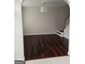 Open living room with hardwood floors and an archway leading to the front door at 5114 Verbena Nw Dr, Acworth, GA 30102