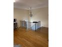Open living area featuring hardwood floors and an ornate chandelier at 1025 Lynwood Pl, Forest Park, GA 30297