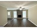 Spacious living room with a stone fireplace, ceiling fan, and durable floors at 1962 Marvin Sw Ln, Atlanta, GA 30311