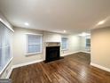 Spacious living area with hardwood floors, flooded with natural light, and a brick fireplace at 2965 Meadowview Se Dr, Atlanta, GA 30316