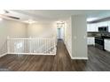 Spacious living room featuring hardwood floors, white staircase and an open floorplan with modern kitchen at 3798 Bakers Ferry Sw Rd, Atlanta, GA 30331