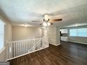 Bright living area with hardwood floors and ceiling fan, flowing into a modern kitchen at 3798 Bakers Ferry Sw Rd, Atlanta, GA 30331