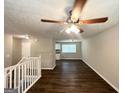 Spacious living area with hardwood floors and ceiling fan, leading to an open kitchen at 3798 Bakers Ferry Sw Rd, Atlanta, GA 30331