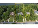 Aerial view of a wooded property lot featuring mature trees and nestled among luxury homes, providing a sense of privacy at 608 Wingspread, Peachtree City, GA 30269