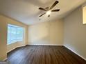 Bedroom featuring a ceiling fan, wood floors, and a large window at 3865 Lehigh Blvd, Decatur, GA 30034