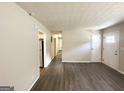 Open living room with dark wood floors, neutral walls, and white doors at 4140 Pierce Rd, South Fulton, GA 30349