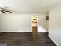 Spacious living room with modern ceiling fan and view into the kitchen at 4140 Pierce Rd, South Fulton, GA 30349