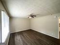 Bright living room featuring dark wood floors and a modern ceiling fan at 4140 Pierce Rd, South Fulton, GA 30349