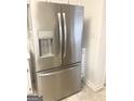 Stainless steel refrigerator in kitchen with water and ice dispenser at 3041 Regal Dr, Mcdonough, GA 30253
