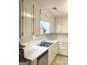Bright kitchen with white cabinets, countertops, and stainless steel sink at 3041 Regal Dr, Mcdonough, GA 30253