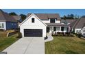 A beautiful two-story home is showcased, complete with a dark colored garage door and landscaped front yard at 15 Dayton Way, Sharpsburg, GA 30277