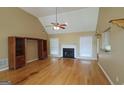 Bright living room featuring a fireplace, hardwood floors, and neutral walls at 109 Windsong Dr, Stockbridge, GA 30281