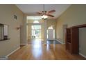 Open-concept living room with hardwood floors, ceiling fan, and great natural light at 109 Windsong Dr, Stockbridge, GA 30281