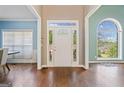Bright entryway featuring hardwood floors, a decorative window over the door, and an arched window at 3338 Hackmatack Dr, Kennesaw, GA 30152