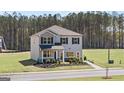 Two-story home with gray siding, black shutters, and a well-manicured lawn at 350 Friendship Oak Way, Hampton, GA 30228