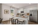 Modern kitchen featuring granite countertops, stainless steel appliances, and a breakfast bar at 350 Friendship Oak Way, Hampton, GA 30228