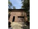 View of the attached garage and side entrance to the home with a brick exterior at 100 Gran De Ct, South Fulton, GA 30349