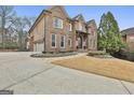 Handsome brick home featuring professional landscaping and a three-car garage at 202 Firefly Ct, Peachtree City, GA 30269