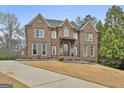 Stately brick residence with a well-maintained lawn and classic design elements at 202 Firefly Ct, Peachtree City, GA 30269