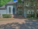Inviting front entrance with brick archway and steps leading to a large double door entry at 101 Glen Eagle Way, Mcdonough, GA 30253