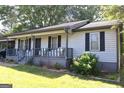 Charming single-story home featuring a cozy front porch and landscaped yard at 4793 Davenport Nw Trce, Acworth, GA 30101