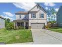 Charming two-story home with well-manicured lawn, inviting curb appeal, and attached two-car garage at 150 Ivy Chase Loop, Dallas, GA 30157