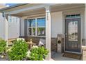 Inviting front porch with seating area, lush greenery, and a charming entrance to the home at 150 Ivy Chase Loop, Dallas, GA 30157