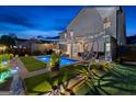 Gorgeous backyard at night featuring a private pool and lounge area with stylish lighting at 65 Hill Top Cir, Grantville, GA 30220