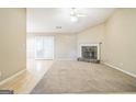 The living room features a stone fireplace, vaulted ceiling, and glass doors at 110 Tamarack Trl, Mcdonough, GA 30252