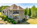 Lovely brick home showcasing a backyard pool, lush landscaping, and an outdoor seating area at 325 Elderberry Trl, Fayetteville, GA 30214