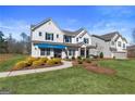 Inviting two-story home with green grass, shrubs, and a peaceful neighborhood view at 284 Villa Grande Dr, Locust Grove, GA 30248