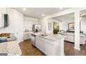 Stylish kitchen open to the living room with stainless steel appliances and granite countertops at 12040 Conrad Cir, Hampton, GA 30228