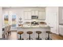 Bright kitchen featuring a central island with seating and modern appliances at 12040 Conrad Cir, Hampton, GA 30228