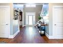 Elegant foyer with hardwood floors, a high ceiling, and a view of the front door and staircase at 109 Lighthorse Blvd, Mcdonough, GA 30252