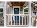 Inviting front porch with a blue door and decorative wood ceiling at 3378 La Vista, Hapeville, GA 30354