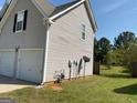 A view of the side of the home with a two car garage and vinyl siding at 1028 Field View Dr, Mcdonough, GA 30253