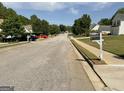 A charming street view showing homes and foliage, with the home's address marker at 1028 Field View Dr, Mcdonough, GA 30253