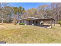 View of the home from the back, showing a covered patio and spacious yard at 315 S Bethany Rd, Mcdonough, GA 30252