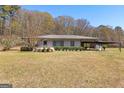 Single story home with a long covered carport and manicured greenery at 315 S Bethany Rd, Mcdonough, GA 30252
