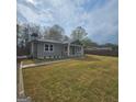 Well-manicured lawn and gray siding create a welcoming exterior for this single-story home at 487 Eastside Dr, Dacula, GA 30019