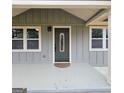 A gray house with a green front door, white trim, and manicured landscaping at 487 Eastside Dr, Dacula, GA 30019
